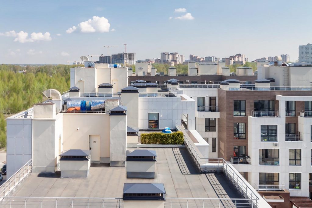 Flat roof with air conditioners on top modern apartment. 