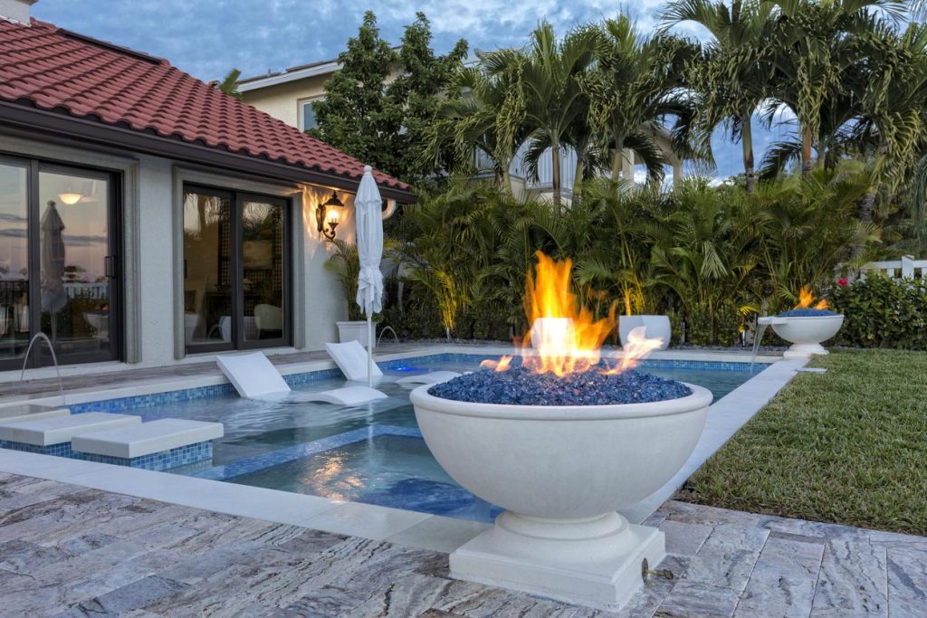Beautiful swimming pool with fire pots.